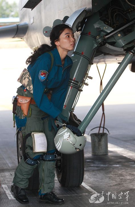 One of the ten first Chinese female JH-7A pilots doing a preflight check of her fighter-bomber Xian JH-7A, at an undisclosed air base in Shandong Province, China, on July 2, 2015. Chinese Female, Jet Fighter Pilot, Pilot Uniform, People's Liberation Army, Female Pilot, Female Fighter, Aerospace Engineering, Military Girl, Female Soldier