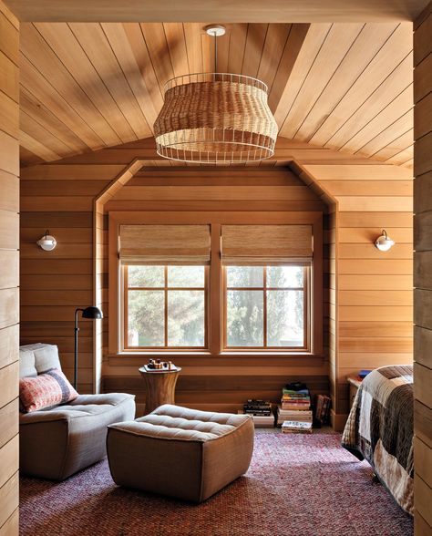 The daughter’s sleeping porch-style bedroom includes a sitting area with a chair and ottoman by Ethnicraft. Lighting fixtures include a Blu Dot pendant, Visual Comfort & Co. floor lamp and RBW wall sconces. Hoedemaker Pfeiffer, Bainbridge Island Washington, Woven Dining Chairs, Porch Styles, Sleeping Porch, Artisan Furniture, Rustic Retreat, Bainbridge Island, Old Farm Houses