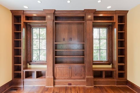 Stained wood custom built in with window seats, bookcases, and media storage in custom home study by BCN Homes in Arlington, Virginia. Built In Bookcase Around Window, Builtin Bookshelves, Farmhouse Life, Living Room Upgrades, Slope House, Stained Window, Arlington Virginia, Window Seats, Home Library Design