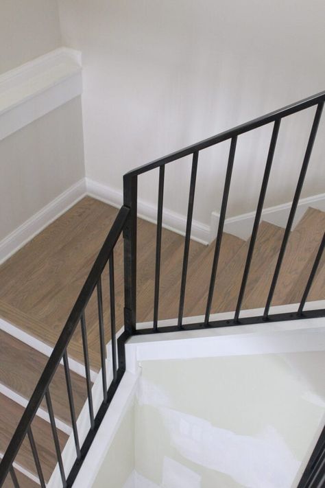 Black metal staircase railings Split Level Staircase Ideas Railings, Painting Metal Stair Railings, Black Metal Banister, Black Metal Staircase, Staircase Transformation, Metal Staircase Railing, Lily Chandelier, Banister Ideas, Black Stair Railing