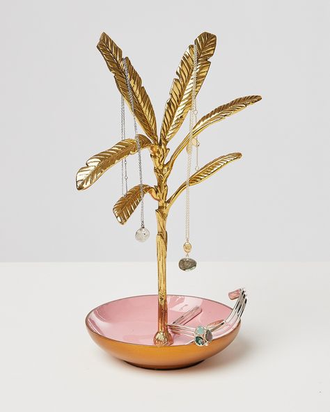 Take your jewelry storage to leafy levels with the Banana Leaf Jewelry Stand, finished in a golden hue. With a pink trinket dish base for storing rings and earrings, hang your longer pieces from each intricate leaf of this jewelry holder. Pink Jewellery, Jewellery Stand, Pink Banana, Jewellery Holder, Christmas Gift Shop, Oliver Bonas, Leaf Jewelry, Pink Jewelry, Jewellery Storage