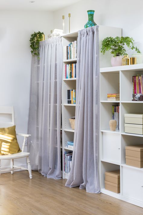 Shelving units are the friend of every home office. But lots of files, books and equipment can look unsightly and distract you from your work. A clever soloution is- floaty voile curtains screen clutter and add to the overall scheme Curtain For Bookshelf, Curtain Hiding Storage, Shelves With Curtains Covering, Curtain Over Bookcase, Curtains To Hide Storage Shelves, Voile Curtain Ideas Bedrooms, Bookshelf With Curtain, Shelf With Curtain, Bookshelf Curtain