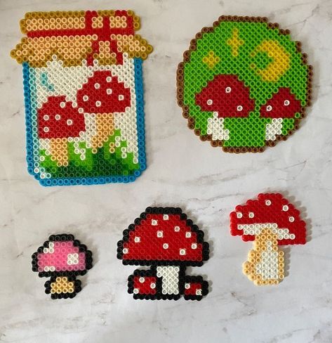 Mushroom perlers Fuse Beads Mushroom, Mushroom Melty Bead Patterns, Perler Bead Art Mushroom, Peeler Bead Mushroom, Cute Bead Art Ideas, Mushroom Pearl Beads, Perler Bead Cup Cover, Small Mushroom Perler Bead Patterns, Mushroom Fuse Bead Patterns