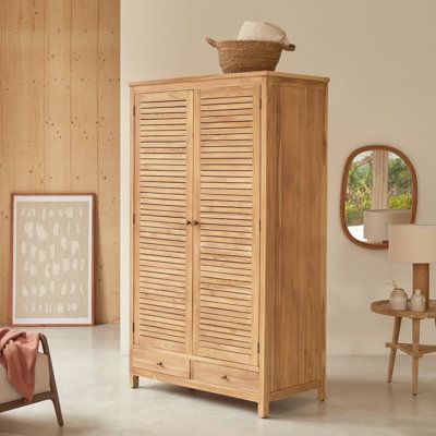 Charm and elegance combine in the Suzette teak wardrobe. Natural solid wood lovers will appreciate this beautiful piece of design and craftsmanship. Equipped with plenty of storage space, it is ideal for storing your clothes and other linens. The fine lines of the design combine with warm teak wood to produce an overall appearance of class and refinement. | Tikamoon Suzette Wardrobe Brown 77.0 x 45.0 x 24.0 in, Solid Wood | C007913292 | Wayfair Canada Teak Wardrobe, Cupboard Wardrobe, Wardrobe Cabinets, Wardrobe Armoire, Raw Wood, Cabinet Makers, Solid Wood Furniture, Teak Wood, Wood Furniture