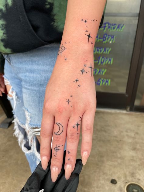 Tattoo, hand tattoo, crescent moon Stardust Hand Tattoo, Galaxy Finger Tattoo, Sun Moon Star Hand Tattoo, Astronomy Hand Tattoo, Starry Hand Tattoo, Hand Tattoos Moon And Stars, Hand Sparkles Tattoo, Celestial Hand Tattoos For Women, Sun Moon Hand Tattoo