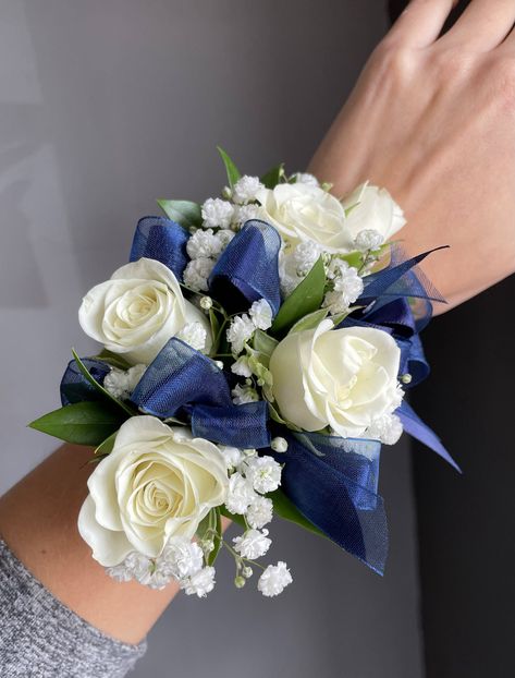 Wrist corsage and boutonniere pair of white spray roses, babies breath and navy blue ribbon. 

Orange Florist | Flower Delivery by The Dizzy Daisy
#thedizzydaisy #floral #bridal #weddings #weddingfloristOC #ocweddings #orangecountyweddings #orangecounty #bridalparty #bridesmaids #groom #groomsmen #weddingday #weddinginspiration #love #inlove #ido #weddingflowers #weddingideas #justmarried #chic #trends #elegant #beautiful #corsage #boutonniere #wristcorsage White And Navy Boutonniere, Corsage Navy Blue Dress, Navy Blue Prom Flowers Wrist Corsage, Blue Corsage Homecoming, White And Navy Corsage, Corsage Prom Navy Blue, Prom Flowers For Blue Dress, Navy Blue And White Corsage, Navy Blue Prom Corsage