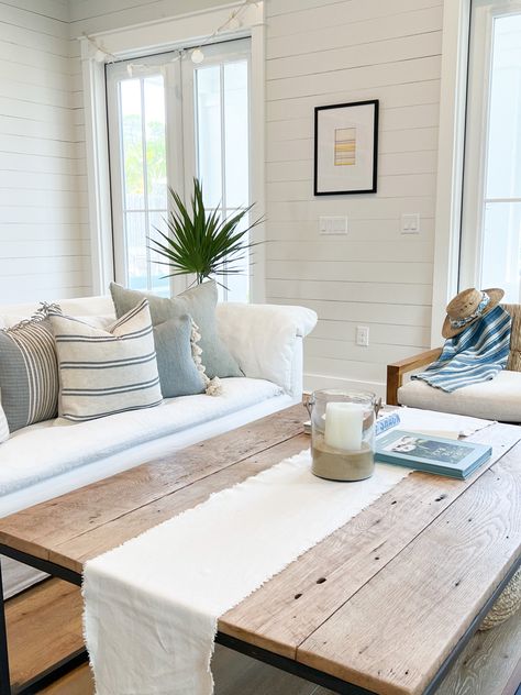 Coastal cottage in shades of white with blue accents. Decor by LINEN & SAND shop. Coastal Farmhouse Guest Room, Shiplap Coastal Living Room, Modern Coastal Throw Pillows, Coastal Throw Pillows Living Room, Southern Coastal Living Room, Coastal Couch Pillows, House Decor Farmhouse Style, Coastal Basement, Coastal Farmhouse Living Room Ideas