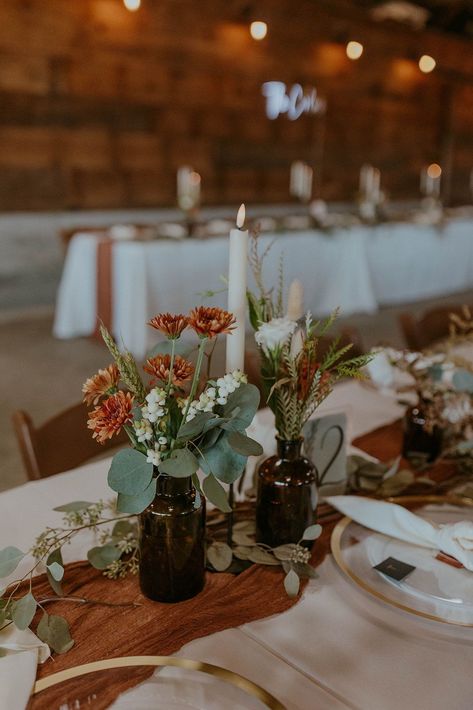 For their rustic meets modern wedding, Sarah and Kelton opted for simple neutral centerpieces with gorgeous boho flowers. Rustic Lodge Wedding Decor, Sage Green And Rust Wedding Centerpieces, Simple Boho Wedding Arch, Brown Vases Wedding, Fall Floral Arrangements Wedding Centerpieces, Wedding Centerpieces Maroon, Wedding Table Simple Decor, Rustic Wedding Decor Table Centerpiece, Rustic Flower Centerpieces