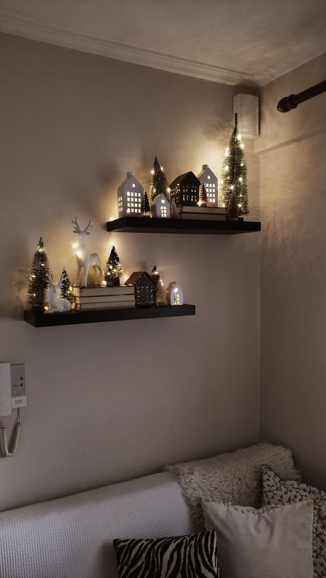 Christmas Decor Ideas Village, Christmas Lights On House Interior, Christmas Decor For Floating Shelves, Black Christmas Village Houses, Mini Christmas Tree Ideas Bedroom, Small Christmas Display, Xmas Decorations Ideas Living Room, Christmas Village Decor Display Ideas, Christmas Mini Houses Display