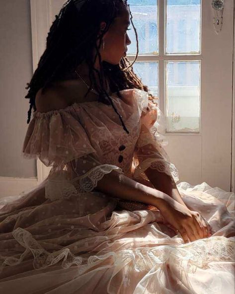 Close up shot of a girl—dressed in a champagne colored, off the shoulder ballgown with white polka tulle sleeves—sitting by and looking out the glass-pane windows on a white door. Light pouring in from behind Victorian Aesthetic Women, Black Victorian Woman Aesthetic, Ballgown Pose Reference, Victorian Brothel Aesthetic, Rich Victorian Aesthetic, Victorian Aesthetic Clothes, Victorian Fantasy Aesthetic, Ballgowns Victorian Aesthetic, Ballgown Pose