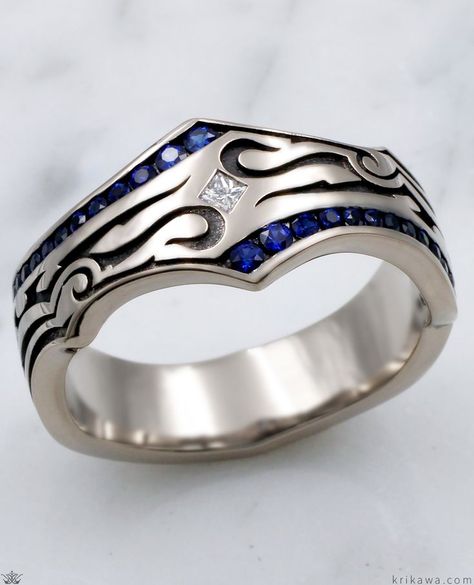 This phenomenal wedding band for men was inspired by tribal tattoo imagery. Over one quarter carat of blue sapphires is channel set in the ring, with a white princess cut diamond flush set diagonally in the center. The recesses are darkened. Truly a stand apart ring. To choose different colors for the accents in the channels, just select your choice of fancy diamonds or sapphires! Jewelry Rings Unique, Blue Wedding Band, Wedding Band For Men, Dream Wedding Ring, Sapphire Wedding Rings, Plain Rings, Sapphire Wedding Band, White Princess, Princess Cut Diamond