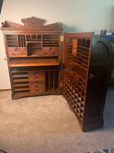 Solid walnut with matching burl panels in excellent restored condition.  Attributes include:  - Large knob latches  - Pull out writing surface  - Desk rolls on large wheels  - Leatherette and post board file boxes with ring pulls (48 to fill lower righthand side)  - Cast bronze mail slot on exterior  - Interior bronze letter holder - Tall gallery with incised carvings atop Joseph Moore worked for Wooton (top-of-the-line desks) for several years, before breaking out on his own.  More information Hobby Desk Ideas, Wood Work Desk, Map Cabinet, Art Desks, Cabinet Desk, File Boxes, Mail Slot, Ring Pulls, Unique Desks