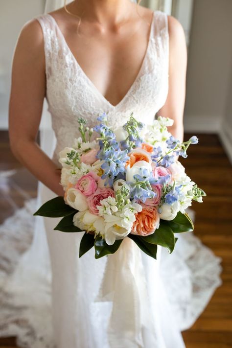 Bridal Bouquet Tulips, Wedding Bouquet With Delphinium, Pink Blue Yellow Wedding Flowers, Peach And Blue Bridesmaid Bouquet, Light Blue Pink And White Bouquet, Pink Yellow Blue Bridal Bouquet, Ranunculus Orange, Bouquet Tulips, Blue Orange Weddings