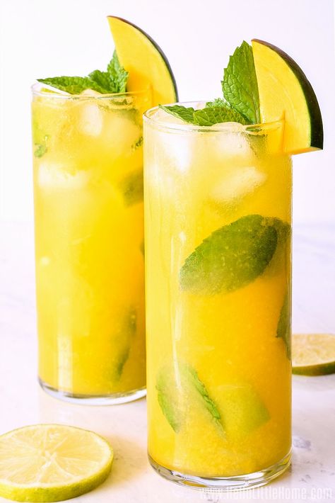 Easy Mango Mojito Recipe ... a refreshing Fresh Mango Cocktail that’s impossible to resist! Learn how to make the BEST Mango Mojito using simple, delicious ingredients: fresh mango puree, mint, lime, club soda, and rum. This Mango Mint Mojito is an Easy Light Rum Cocktail Recipe with tropical flair that’s as perfect for relaxing afternoons as it is for your next party. Best of all, this mouthwatering Mango Rum Drink is fast to make ... it’s the perfect Summer Drink! | Hello Little Home Tropical Mojito Recipe, Tropical Mojito, Mango Rum Drinks, Flavored Mojito Recipe, Mango Mojito Recipe, Mango Mint Mojito, Mojito Recipe Classic, Mango Cocktail, Mango Rum