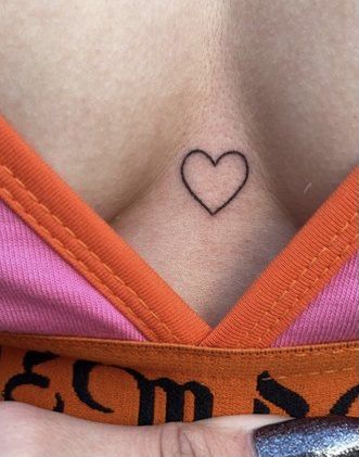 Heart In Middle Of Chest Tattoo, Heart Tattoo Middle Of Chest, Heart Tattoo In Between Chest, Chest Tattoo Female Heart, Heart Tattoo Sternum, Small Tattoo Between Breast, Tattoo Between Breast Simple, Heart Chest Tattoo Female, Chest Tattoo Heart