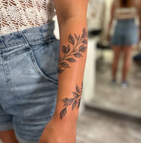 30 Best Vines Tattoo Ideas You Should Check Birth Flower Arm Tattoos For Women, Vine And Leaf Tattoo Design, Vine Tattoos Fine Line, Tattoo Arm Wrap Women, Writing Tattoo Cover Up Ideas, Large Vine Tattoo, Forearm Floral Wrap Tattoo, Womens V Line Tattoo, Full Arm Vine Tattoos For Women