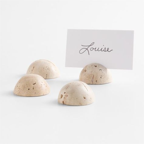 Hemispheres of pure travertine serve as chic holders for personalized place cards. Slotted to hold a card indicating seating or identifying a dish on a buffet table or cheese spread, each holder in the set exhibits the natural earth tones and unique markings of travertine.   • Travertine  • Slotted to hold place cards  • Due to the characteristics of natural stone, markings and coloration will vary  • Wipe clean with damp cloth  • Made in India Travertine Round Placecard Holders, Set of 4 Wedding Table Setting With Name Card, Wedding Thrift, Place Holders Wedding, Wedding Seating Chart Display, Minimalist Stationery, Personalized Place Cards, Colorful Wedding Invitations, Place Card Holder, Birthday Dinner Party