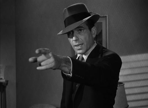 Editor’s note: This is a guest article from Will Whitson.  “[He was] as honest as you can expect a man to be in a world where it’s going out of style.” —The Big Sleep Even if you’ve never picked up one of Raymond Chandler’s novels about quintessential noir private detective Philip Marlowe (or seen him […] 60s Detective, 1930 Detective, Film Noir Detective, Film Noir Detective Woman, 50s Noir Detective, Best Noir Films, Detective Costume, Dashiell Hammett, Noir Detective