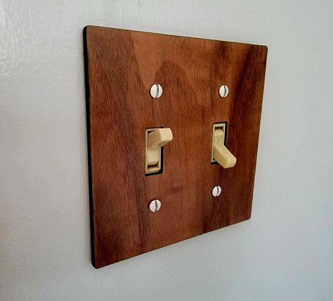 Up your light switch game! These fit standard toggle switch plates. Available in Walnut (shown), Cherry, and Maple. Specify 1, 2, 3, or 4 switches! Looking for large toggle switch style covers? Let me know, and I can also create those. These can also be made as custom orders with custom laser etching - light names, images, etc. Please contact me for more information for a custom order. Please reach out with any questions or issues!   These items are mostly made to order, and may take a couple of Wood Outlet Covers, Light Names, Switch Socket, Laser Cut Wood Crafts, Toggle Light Switch, Light Switches, Light Switch Plate Cover, Vintage Eclectic, Toggle Switch