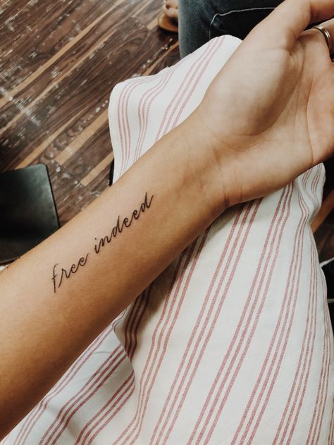 Free indeed tattoo The Word Free Tattoo, Loved By God Tattoo, Minimal Verse Tattoo, Biblical Saying Tattoos, Free Indeed Tattoo, Be Free Tattoo Ideas, Minimalistic Biblical Tattoos, Free Tattoo Word, Redeemed Tattoo Fonts