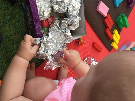 Opening foil wrapped toys.    This is one of our toddler’s most favorite activities. Setting up is easy: you just wrap some toys in aluminum foil and let your child unwrap them. It’s great for developing fine motor skills, learning animal names or names of objects you are wrapping and it’s just fun! We also wrap some wind-up toys in foil, and once each one is discovered we say the name of the animal and wind it up. 13month Old Activities, Activities For One Year Olds, Toddler Games, Fine Motor Skills Activities, Games Activities, Games For Toddlers, Toddler Play, Indoor Play, Toddler Fun