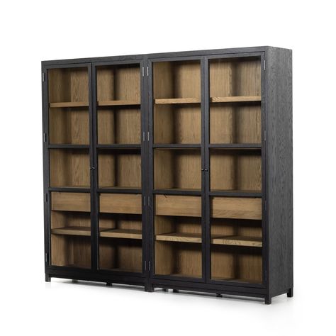 Two-tone transparency. Black drifted oak frames lighter interior shelving for subtle but striking contrast. Glass doors allow for prized possessions to dazzle on full display while spacious interior drawers add out-of-view storage. Product Overview ﻿Available Finishes: Drifted Matte Black ﻿Dimensions: ﻿95"L x 18"W x 83 Library At Home, Paneled Doors, Kitchen Updates, Tempered Glass Door, Tall Cabinet, Frame Light, Amber Interiors, Modern Storage, Glass Cabinet