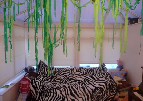 Crepe paper vines hang from more crepe paper or string. Crepe Paper Vines, Diy Jungle Vines, Diy Jungle Vines Brown Paper, Green Streamer Backdrop, Ruffled Crepe Paper Streamers, Seaweed Streamers Under The Sea, Brewery Decor, Crepe Streamers, Wild Kratts Party