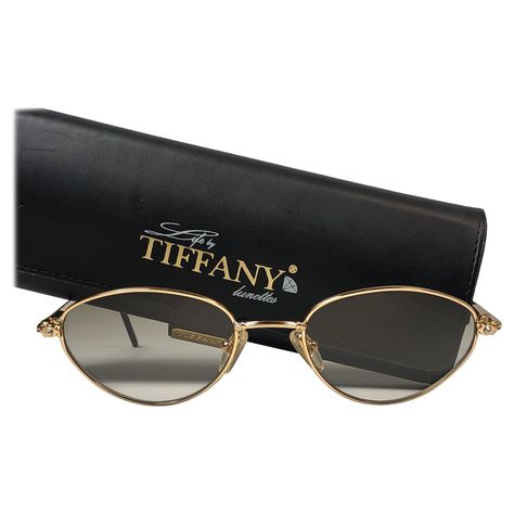 New Tiffany gold plated cat eyes frame. Spotless brown gradient lenses. Made in Italy. Produced and design in 1990's. This item may show minor sign of wear due to storage. 1960s Sunglasses, 1970s Sunglasses, Tiffany Gold, Tiffany Rose, Black Round Sunglasses, Vintage Tiffany, Sunglasses Logo, Chanel Sunglasses, Cat Eyes