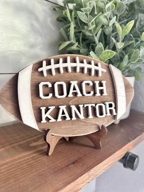 Personalized Desktop Football Coach Sign  - Gifts for Football Coach - PE Coach Gift Personalized - Gifts for Coaches - Football Coach  This sign is 7.8 inches by 4.5 inches made with 1/4 inch wood and 1/4 wood cut out letters. Each football comes with a stand perfect to sit on your favorite coaches desk!  These make great gifts for  end of year gifts, Christmas or back to school!  We make every sign out of real wood - because of this each sign will be unique and have its own variation of knots Gifts For Coaches, Senior Night Football, Soccer Banquet, Football Player Gifts, Football Team Gifts, Football Banquet, Football Coach Gifts, Coach Appreciation Gifts, Coaches Wife