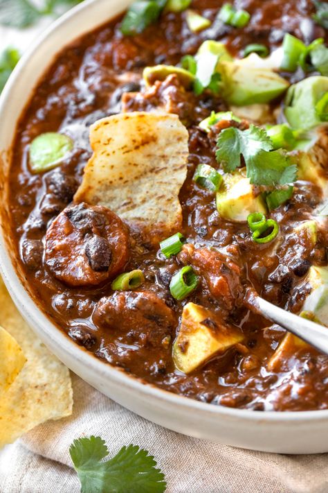 This hearty black bean soup with flavorful Spanish chorizo is brimming with black beans, two types of chilis, plus lots of warming spices! | thecozyapron.com #blackbeansoup #blackbeansouprecipe #blackbeansoupcannedbeans #blackbeansoupeasy #spanishchorizo Bean Soup Mexican, Chorizo And Black Bean Recipes, Black Bean Soup Recipe, Chorizo Sausage, Sweet Potato Chili, Black Bean Soup, Adobo Sauce, Canned Beans, Chipotle Pepper