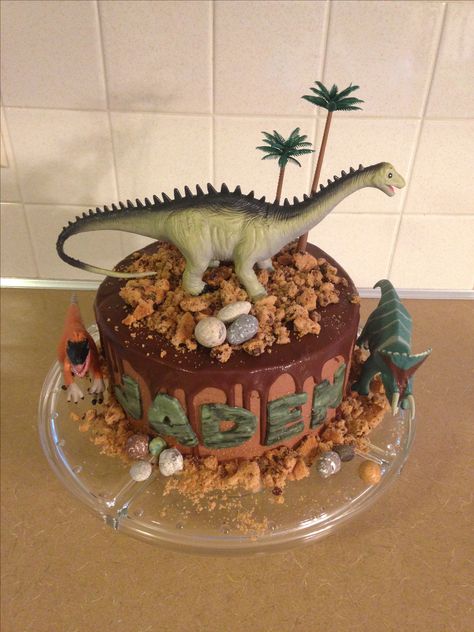 Easy dinosaur birthday cake with crumbled chips ahoy, chocolate rocks and chocolate ganache. Dinos purchased at Hobby Lobby, trees at Michaels. Diy Dinosaur Cake, Red Birthday Cakes, Diy Dinosaur, Chocolate Rocks, Inside Cake, Dino Cake, Dinosaur Birthday Cakes, Dino Birthday Party, Torte Cupcake