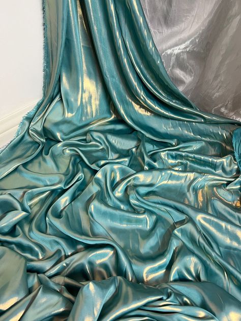 "1 mtr turquoise/gold shimmer on satin fabric This is quality fabric and is silky satin fabric It is 58\" wide (147cm) This is ideal for dress making lining,bridal dress lining, waiste coat,decorations,table runners, and many other projects If more than one quantity is bought it will be sent in one continous length All items are dispatched within one working day (Please note i try my best to get exact color of the fabric there might be a slight different in color due to different montior screens and camera lighting) Any questions feel free to ask and please take time to look at my shop" Green And Gold Fabric, Clothing Fabric Patterns, Shimmer Fabric, Fabric Photography, Image Swag, Elegant Fabric, Decorations Table, Bridal Fabric, Teal And Gold