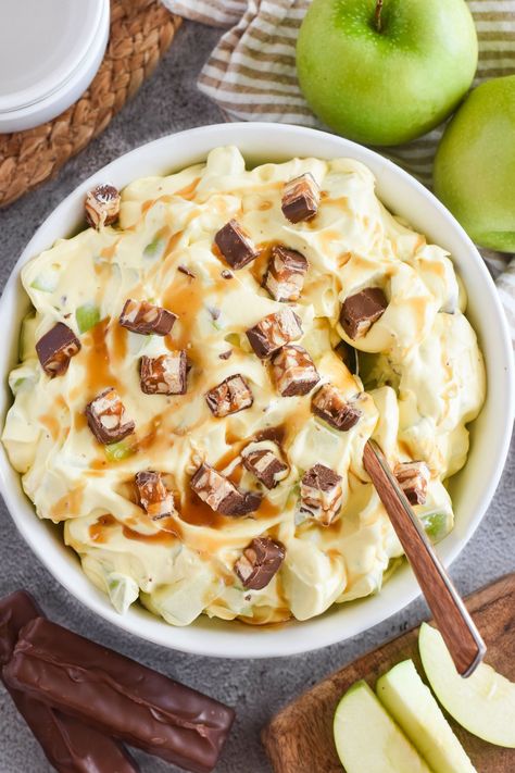 Snickers Salad is an easy recipe combining creamy pudding with chewy candy bars and crisp apples! The perfect side dish...or dessert! Snickers Apple Salad With Pudding, Candy Apple Salad, Apple Snicker Salad Recipe, Snicker Salad Recipe, Snickers Salad Recipe, Snickers Dessert, Snickers Recipe, Dance Around The Kitchen, Snicker Apple Salad