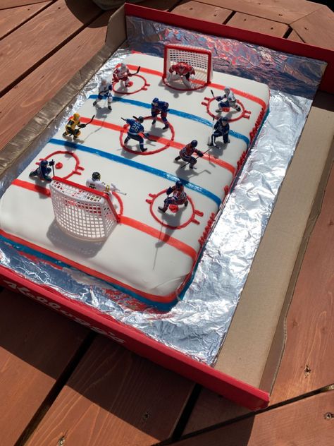 Vanilla cake base, buttercream icing topped with fondant, then we added fruit roll up for the lines and used food colouring to change the white buttercream icing to red and piped it through a bag to make the circles.  Last we added the players and nets! Coach Cake, Hockey Birthday Cake, Happy Birthday Nick, Hockey Cake, Hockey Cakes, Hockey Birthday Parties, Homemade Fondant, Hockey Party, Hockey Birthday