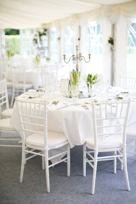 elegant tented wedding reception in all white | white chiavari chairs, white table cloths and napkins | trio of white floral centrepieces on top of round mirros and silver candelabras | A Springtime French Chateau Wedding Chiavari Chairs Wedding, Wedding Table Decorations Elegant, Tent Chair, Wedding Reception Chairs, Round Wedding Tables, Chivari Chairs, Tent Wedding Reception, White Floral Centerpieces, Gold Chiavari Chairs