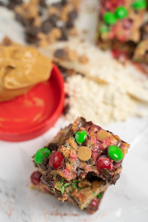 Christmas Monster Cookie Protein Bars | MacroChef MacroChef Greek Yogurt And Peanut Butter, Monster Cookie, Holiday Favorite Recipes, Healthy Sweet Treats, Protein Cookies, Protein Bar, Unsweetened Applesauce, Peanut Butter Chips, Best Protein