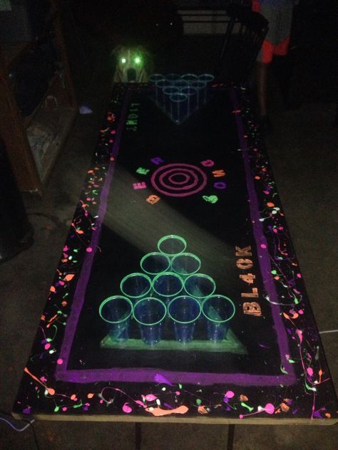 #blacklight #beerpong neon beer pong table glow in the dark beer pong Glow In The Dark Beer Pong Table, Halloween Beer Pong Table, Halloween Beer Pong, Rave Party Ideas, Beer Pong Table Designs, Beer Olympics, 14th Birthday Party Ideas, Beer Olympic, Neon Birthday Party