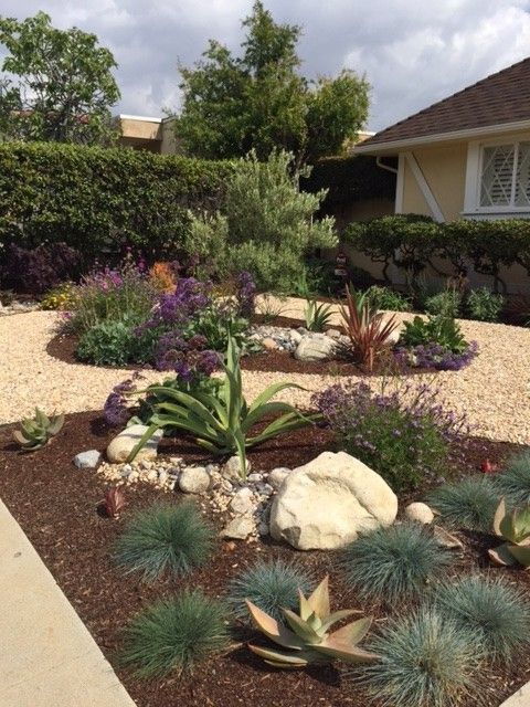 a rock garden in front of a house