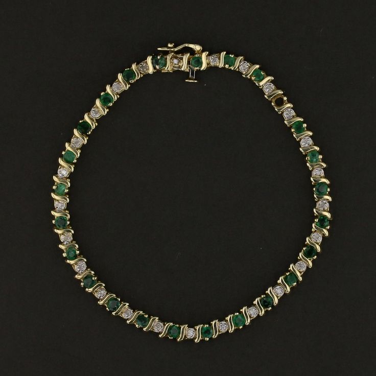 Description: This exquisite vintage 14K yellow gold bracelet features a stunning combination of vibrant green emeralds and sparkling diamonds. Weighing 9.1 grams, this elegant bracelet showcases round-cut emeralds beautifully accented by brilliant diamonds, creating a luxurious and timeless design. Perfect for special occasions or to add a touch of elegance to everyday wear, this piece is a must-have for those who appreciate vintage luxury. Specifications: Metal: 14K Yellow Gold Weight: 9.1 gram Green Diamond Bracelet For Formal Occasions, Green Emerald Bracelets For Formal Occasions, Green Emerald Bracelets For Formal Events, Formal Green Emerald Bracelets, Green Jubilee Gold Bracelet For Formal Occasions, Formal Green Gold Jubilee Bracelet, Formal Green Bracelets With Diamond Accents, Green Bracelets With Diamond Accents For Formal Occasions, Formal Green Diamond Jubilee Bracelet