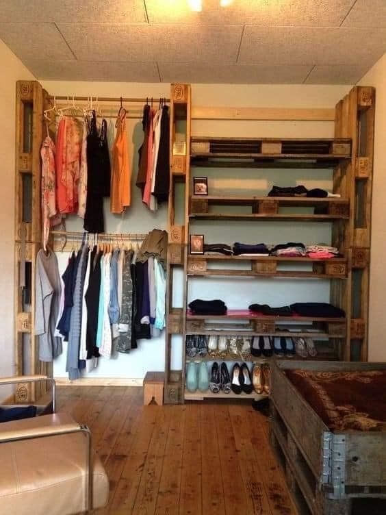 an open closet filled with clothes and shoes