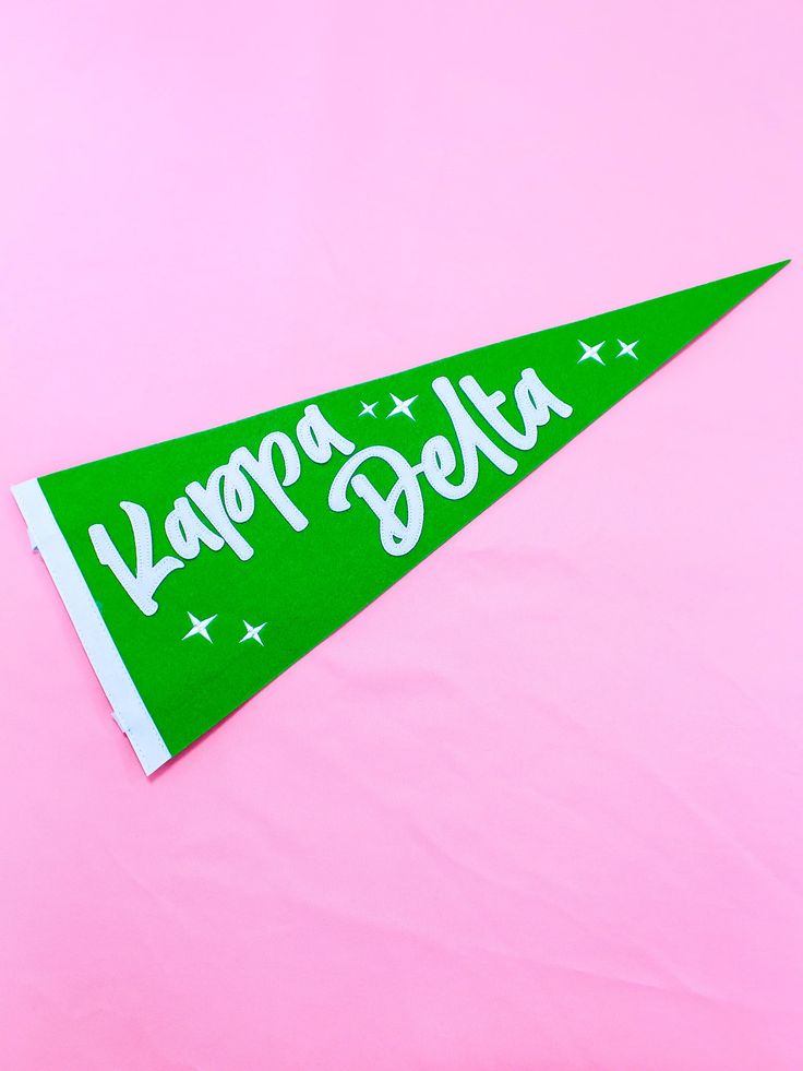 a green happy birthday pennant on a pink background