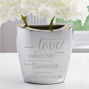 a vase with white flowers in it sitting on a table