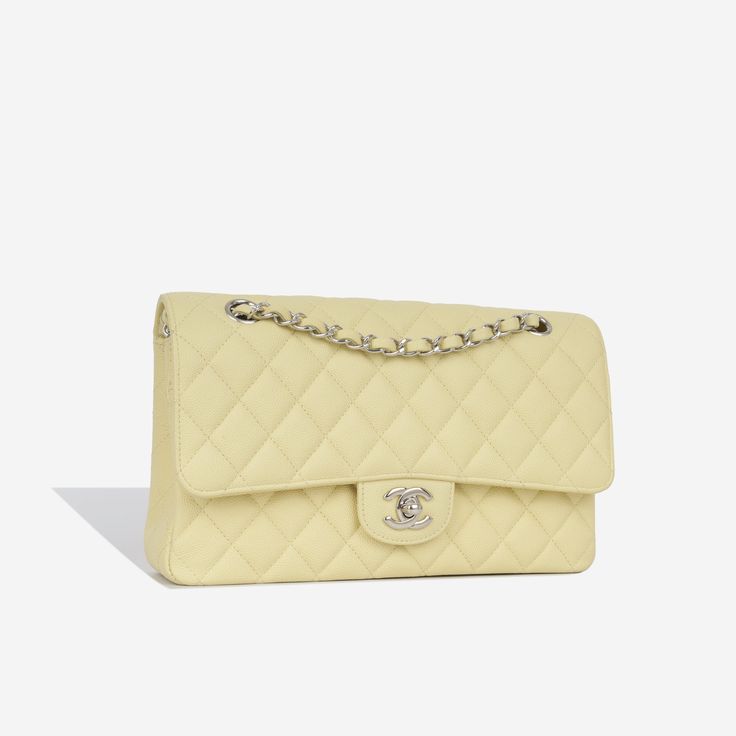 For timeless Parisian-chic there is no better investment than a Chanel classic flap bag. Created in a beautiful pale yellow caviar leather, in the coveted Medium size. This Chanel comes with all the iconic features including multiple compartments and pockets. The interwoven chain sits elegantly on your shoulder or doubled up on your arm.   SPL Exterior  Pale yellow caviar leather Silver tone hardware  CC twistlock closure Slip pocket at rear of bag 2018 production   Excellent condition - some light corner wear and hairline scratches to CC  Interior   Yellow leather interior  Double flap Zip compartment on first flap Two slip pockets at interior wall Excellent condition - one small mark under second flap  Sold with box and dustbag only   SPL  Height 16cm Width 26cm   Depth 7cm High End Handbags, Bags 2014, Neutral Bag, Chanel Classic Flap Bag, Classic Flap Bag, Stylish Shoulder Bag, Chanel Caviar, Black Caviar, Timeless Handbag