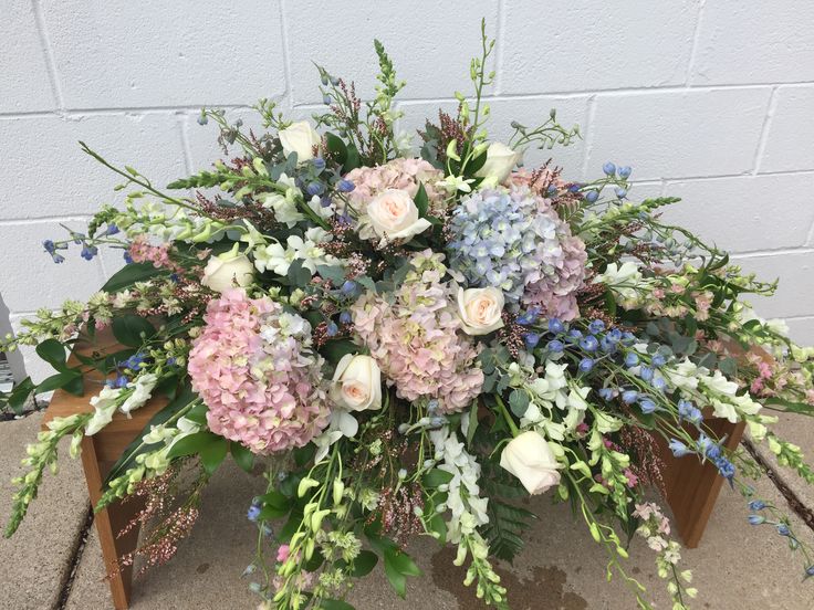 an arrangement of flowers in a wooden box