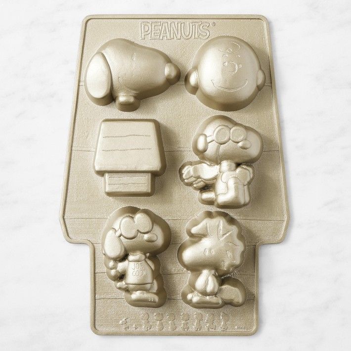 a cookie sheet with peanuts on it and other decorations in the shape of an elephant