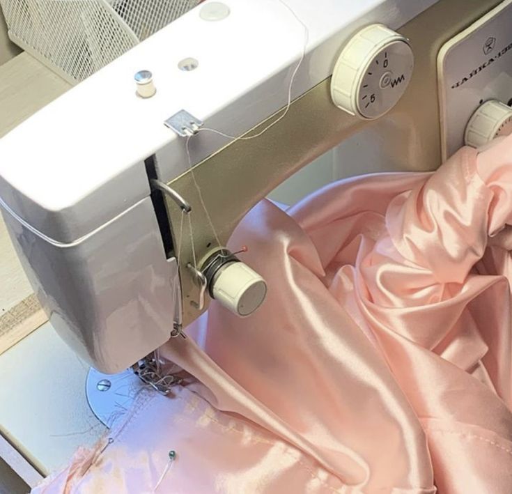 a sewing machine with pink fabric on it