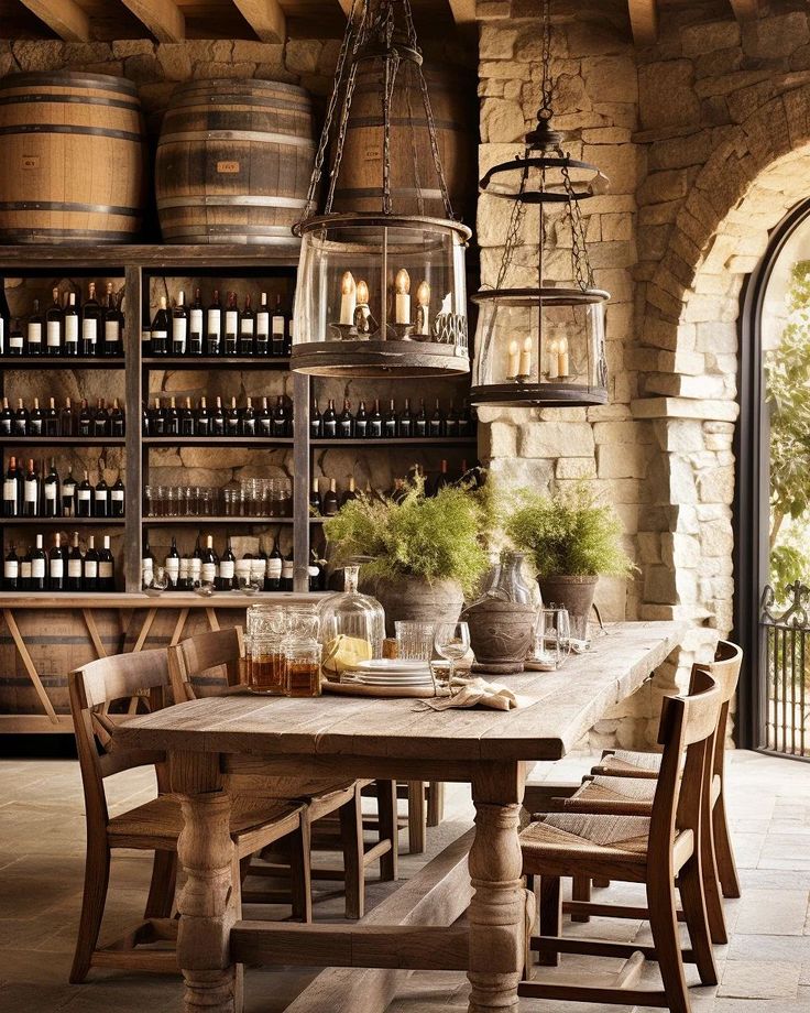 a rustic dining room with an old table and wine barrels on the wall behind it