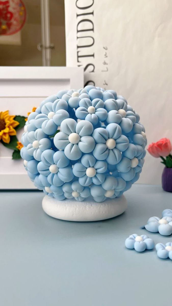 blue and white flowers sitting on top of a table