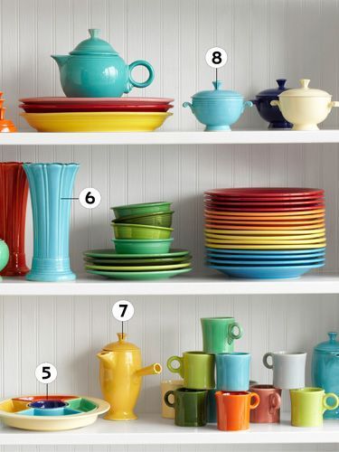 the shelves are full of colorful dishes and cups, with numbers on each shelf above them