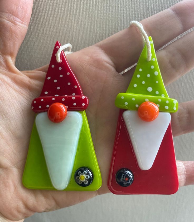 two handmade christmas ornaments in the shape of santa's hats